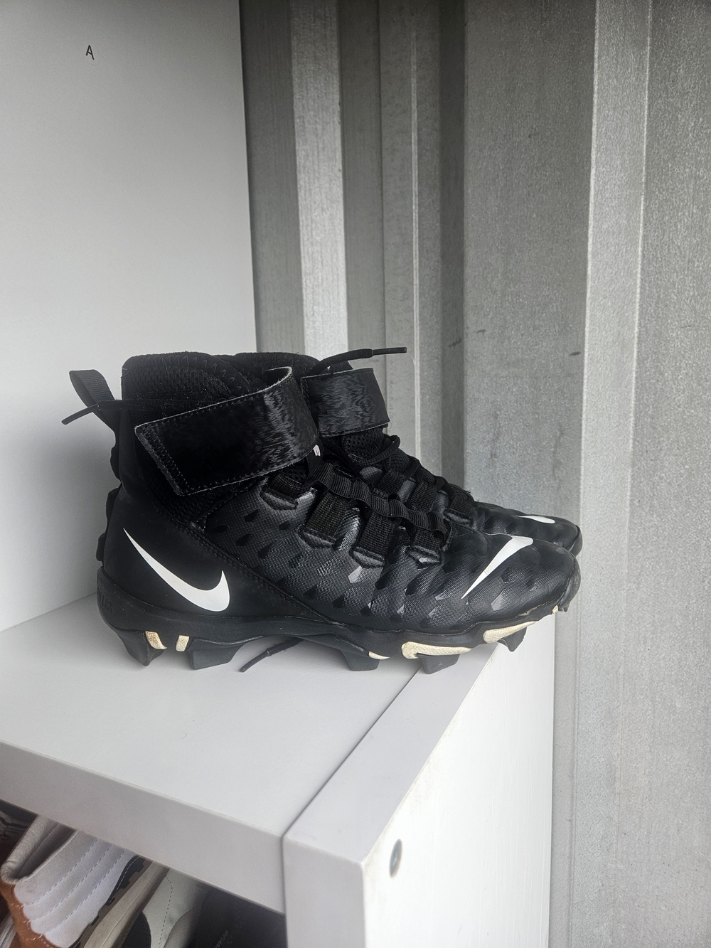Nike Black Football Cleats with White Swoosh